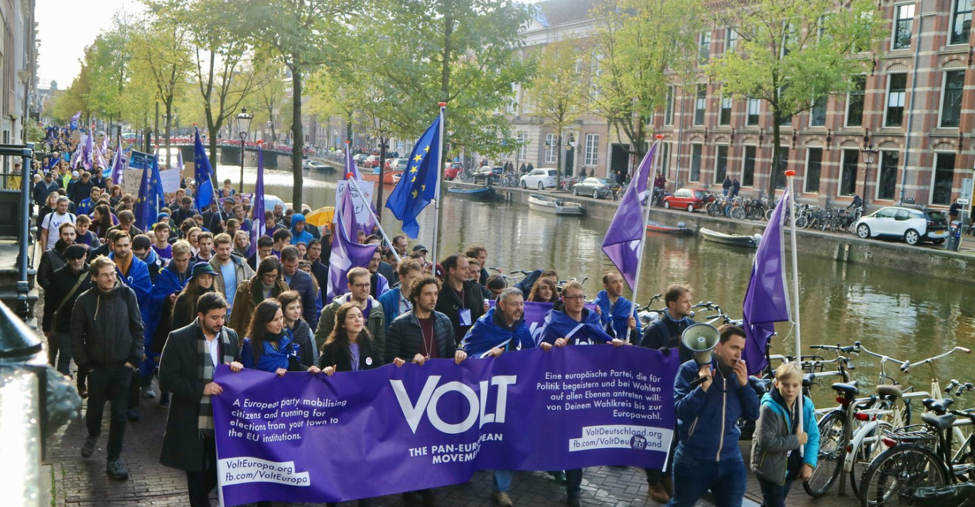 Volt parade in Amsterdam with flag